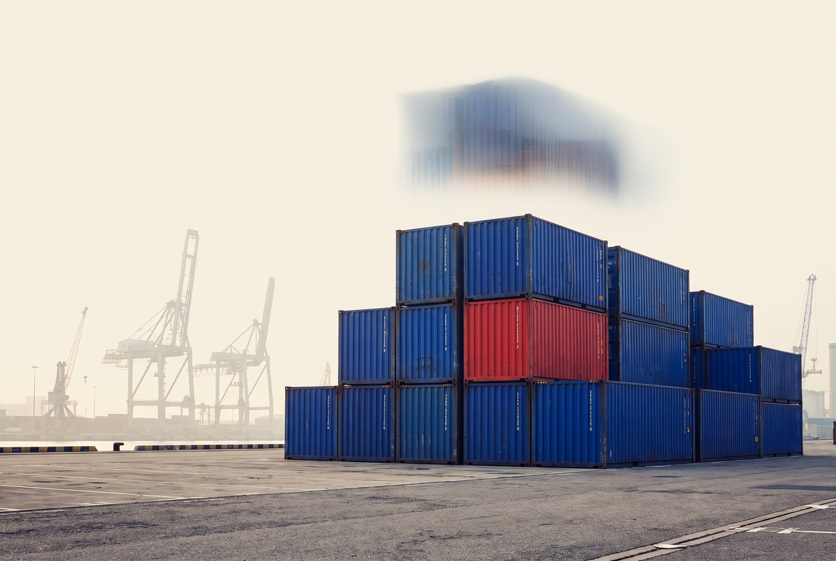 Conteneurs maritimes empilés sur un quai portuaire sous un ciel crème